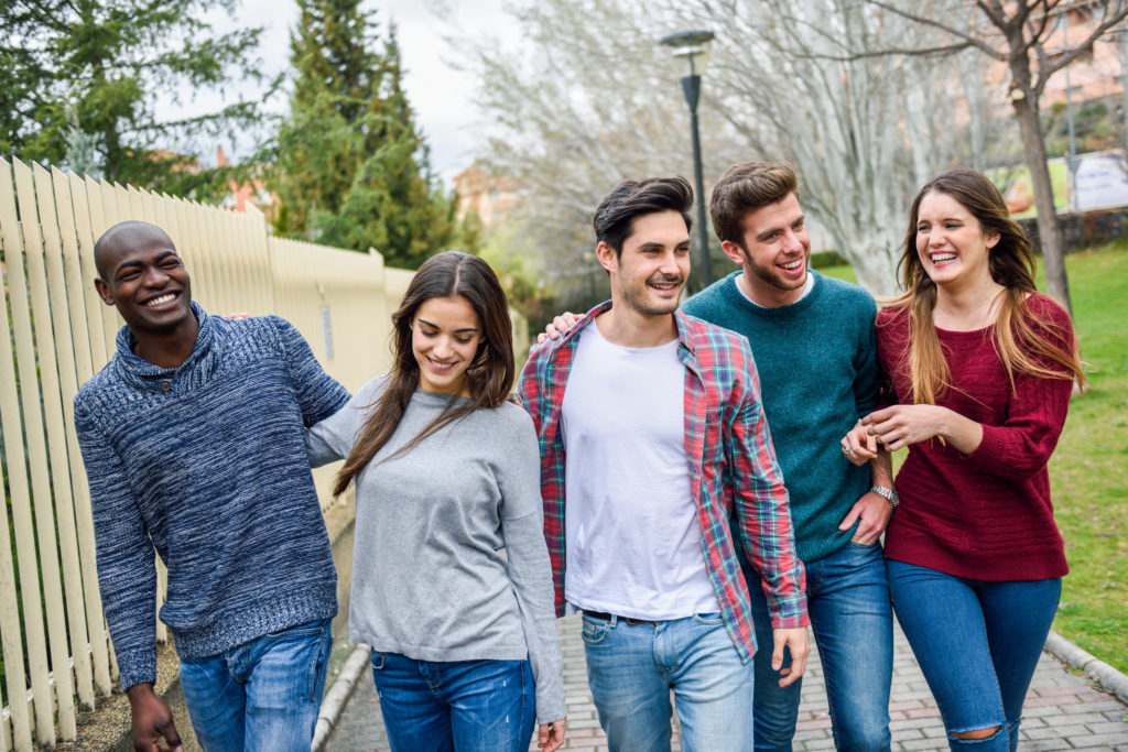 Group of college students walking together on campus