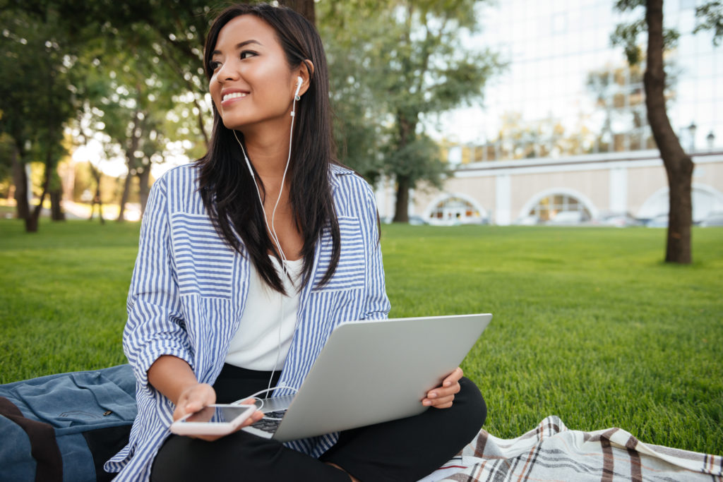 Portrait of female student, filling out a scholarship application on laptop