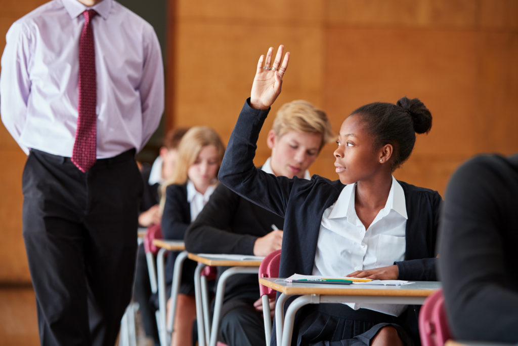 Female student raising hand in class